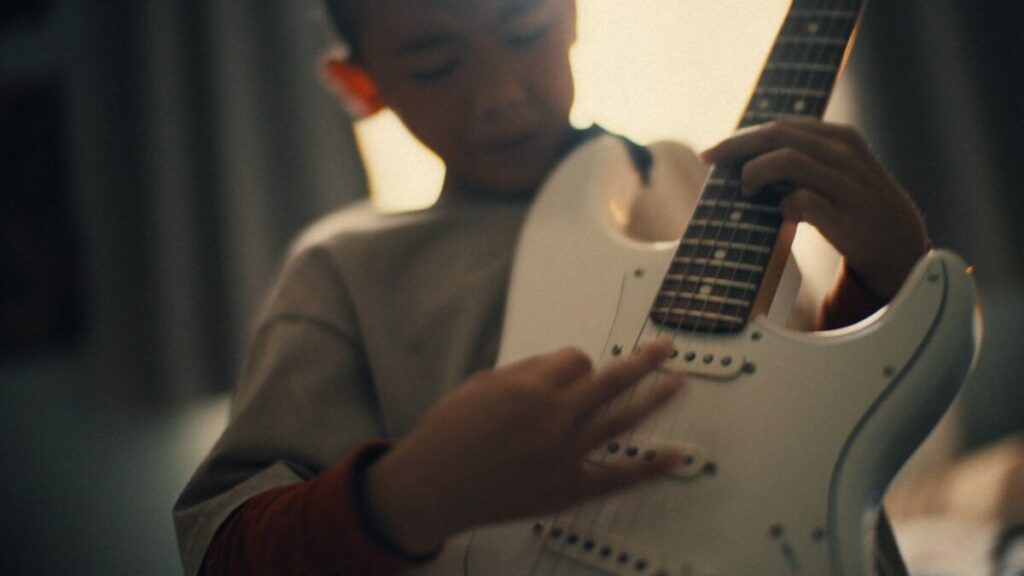 Nine-year-old guitar prodigy jams in his bedoommm focusing intently on his white electric guitar. EDF has joined forces with Lucky Generals to launch a new brand platform, backed by a multi-million pound media plan from Havas Media UK.