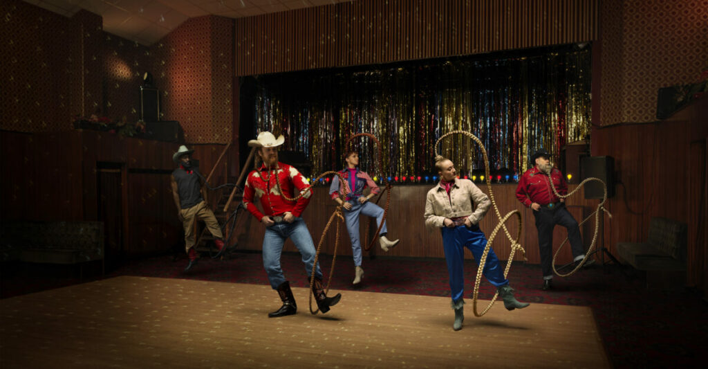 A group of men dance clad in cowboy hats, boots and lazoos. Foxy Bingo is encouraging fans to "get their fox on" and get moving in a new Birmingham based activation.