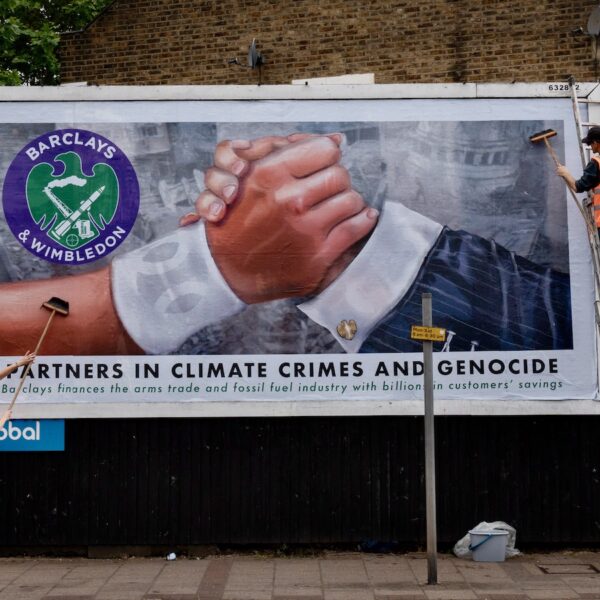 Hacked billboard reads "Partners in climate crisis and genocide". In a protest against Barclays' sponsorship of Wimbledon, activists from anonymous arts collective Brandalism have replaced commercial billboard, bus stop and tube ads surrounding the prestigious tennis tournament, which opens on Monday, with hard-hitting artworks targeting Barclays' links to arms companies and the climate crisis. 30/6/24 Photo Tom Pilston.