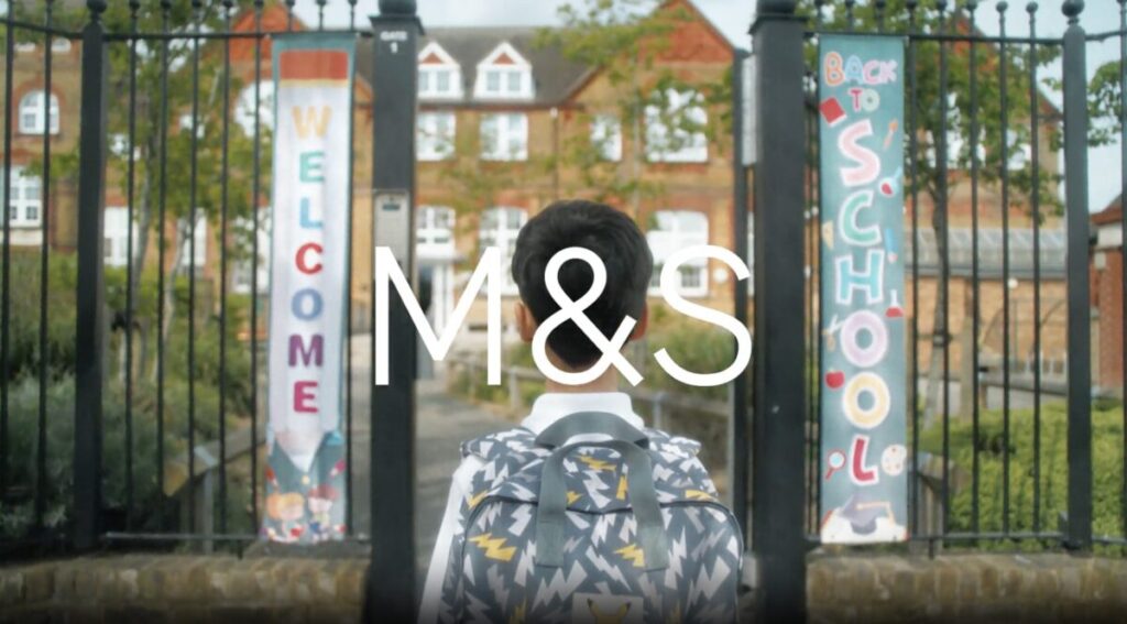 A boy looks right at the school gates, rucksack on shoulders ready for the day to begin. M&S is kicking off its back-to-school campaign with an upbeat and light-hearted spot, the first back-to-school spot from its creative agency Mother.