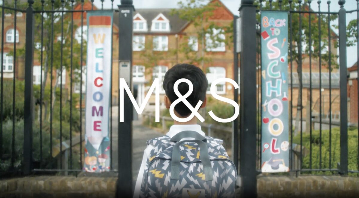 A boy looks right at the school gates, rucksack on shoulders ready for the day to begin. M&S is kicking off its back-to-school campaign with an upbeat and light-hearted spot, the first back-to-school spot from its creative agency Mother.