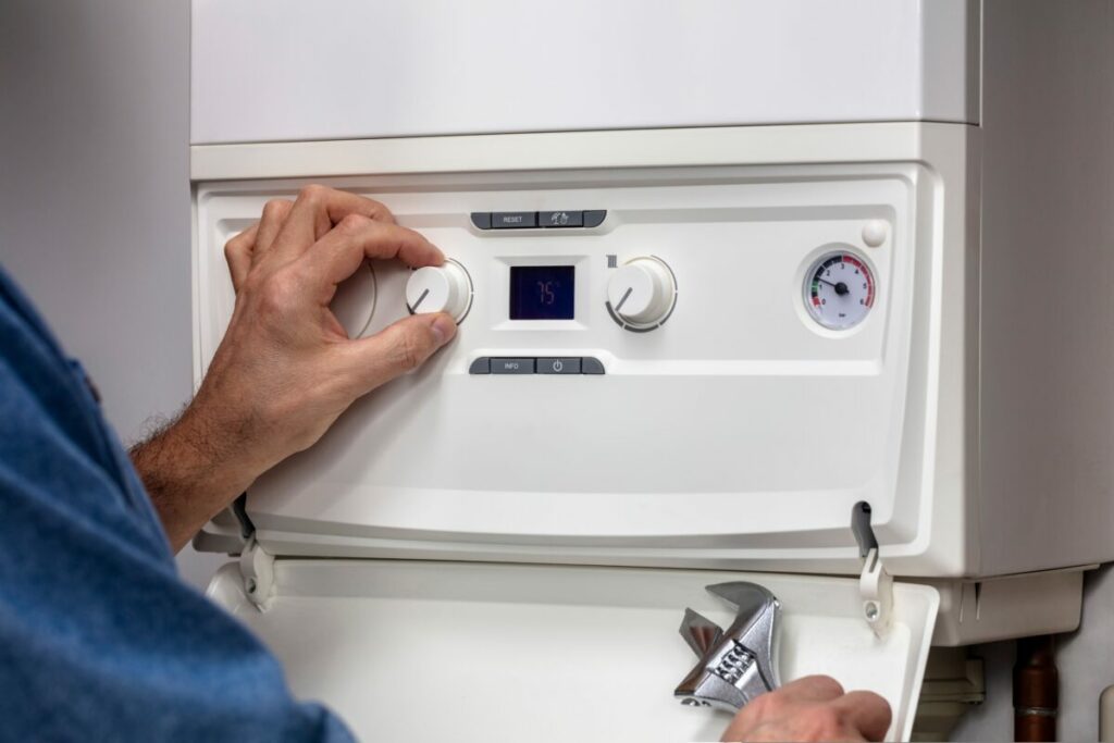 A technician fits a boiler. Worcester Bosch will make changes to how it markets its boilers, after the Competition and Markets Authority (CMA) raised concern about green claims.