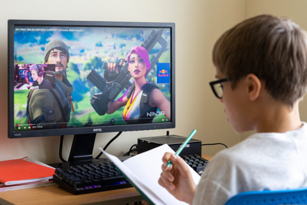 Boy watches Youtube whilst doing homework. YouTube has trumped Netflix, McDonald's, Nintendo and Nike to take the top spot as the coolest brand among kids aged seven to 14.