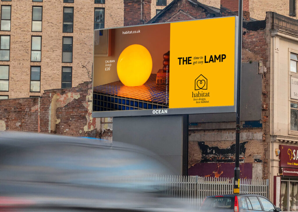 A billboard in autumnal colours. A moodily lit lamp Text reads "The lamp. Time to get cosy". Featuring photographs by Jake Curtis which spotlight the affection we have for our furniture, the new work celebrates Habitat's new brand platform.