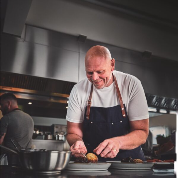 Tom Kerridge focuses intently in a shiny gastropub kitchen as he perfects his placement. M and S is marking 20 years of its gastropub range with a new campaign spotlighting the retailer's collaboration with celebrity chef Tom Kerridge.