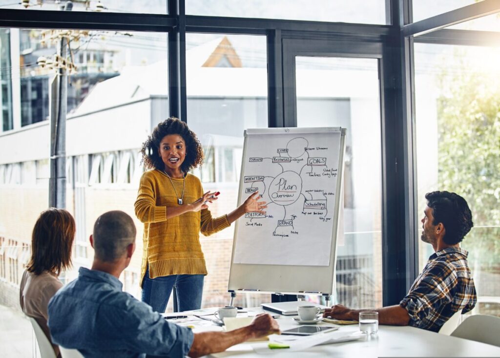 A woman delivers a training course in a meeting room. The Advertising Association and Adwanted UK have created the hub which includes a range of UK-based advertising development opportunities.