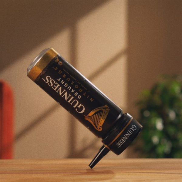 A dancing Guiness nitrosurge device balances on a table in style. Guinness gives a nod to its iconic 1994 'Dancing Man' ad in a film showing a dancing can to illustrate how the nitrosurge device creates the perfect at-home pour.