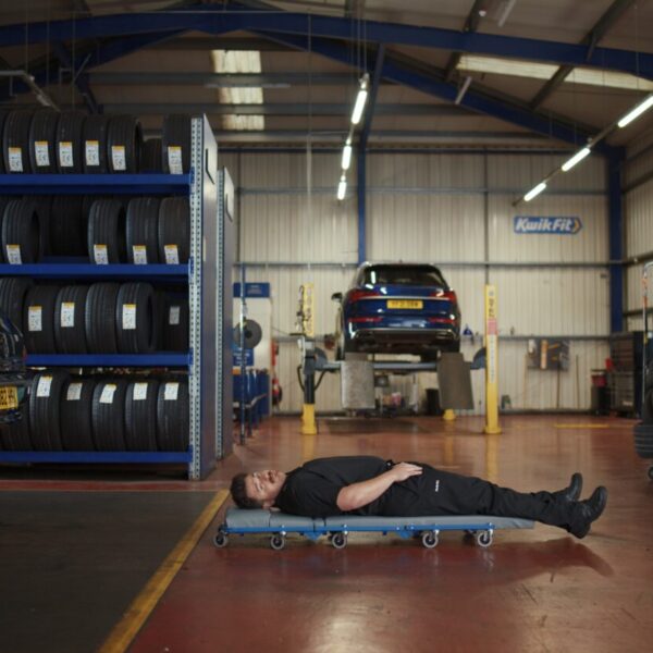 A technician on a mechanic's under-roller. Car mechanic firm Kwik-fit humanises the business's efforts to make sure customers "drive away happy every time" in its newest ad.