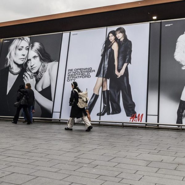 Fashion brand H&M has transformed Westfield Stratford's bustling pedestrian bridge into a festive branded walkway. 
