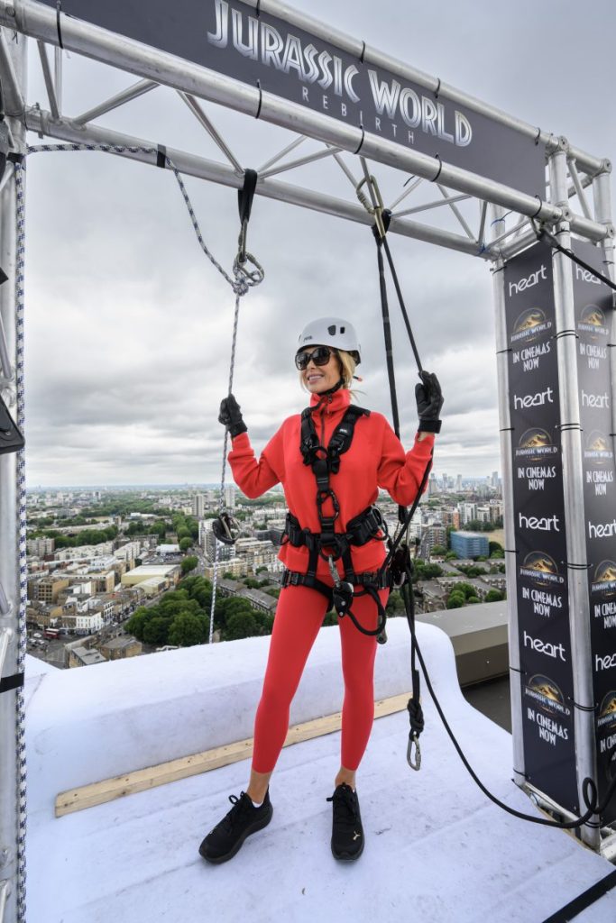 Heart Breakfast's Amanda Holden has abseiled down a 30-storey building in London to mark the release of Jurassic World Rebirth.